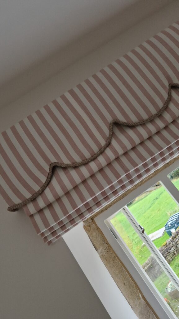 pink striped roman blind with scallop pelmet